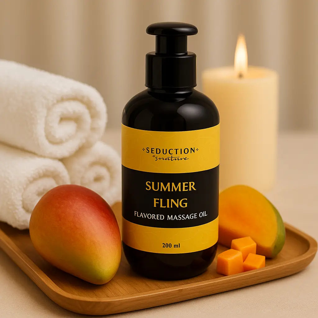 Bottle of 'Summer Fling' flavoured massage oil with mangoes and a candle on a wooden tray